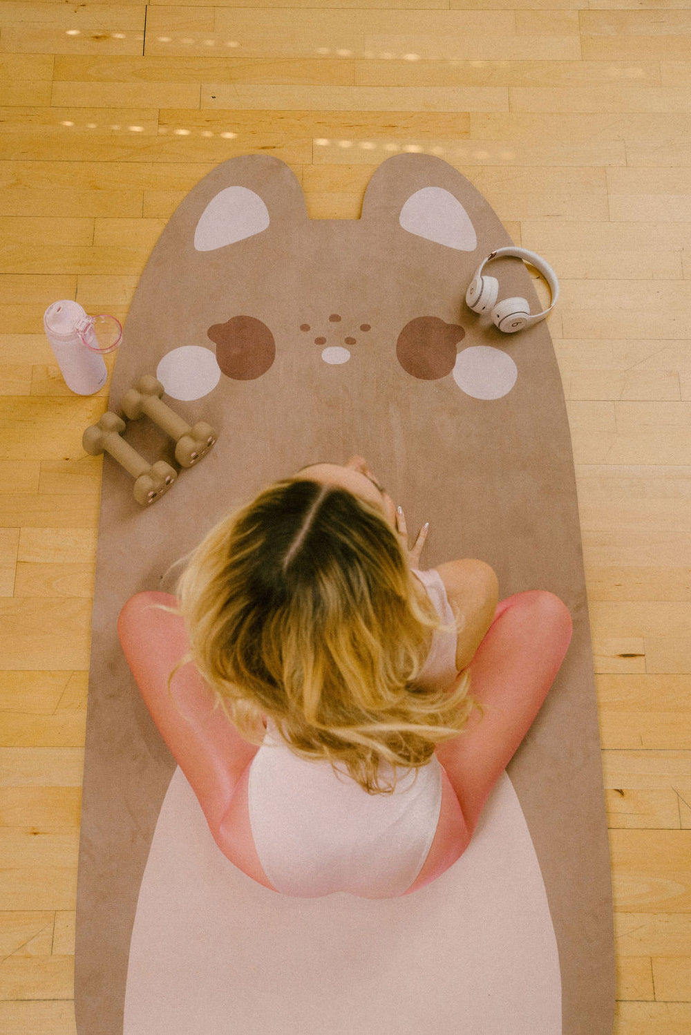 Maple the bear-shaped yoga mat with a tan center and brown accents on a white background